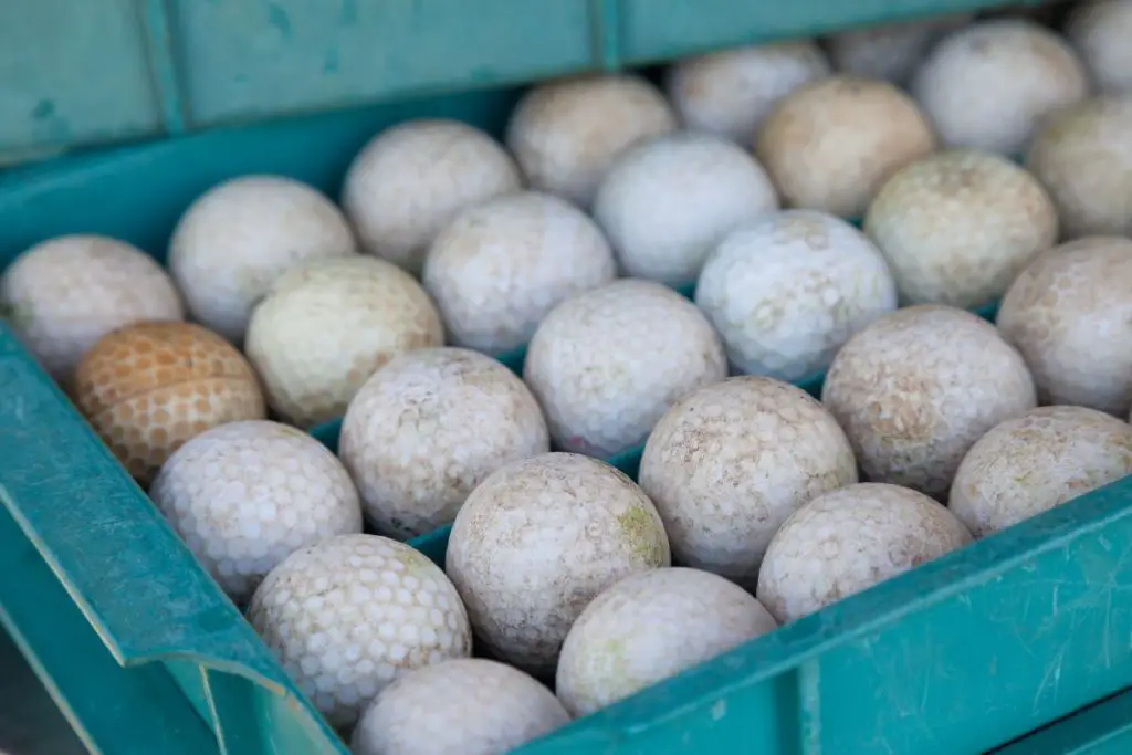 A bunch of dirty golf balls ready to be cleaned