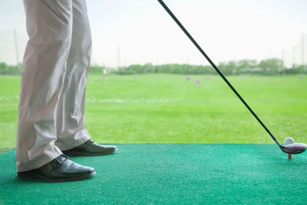 Man golfing at the Topgolf range