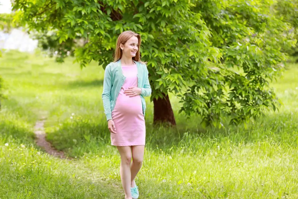Pregnant woman outside taking a walk